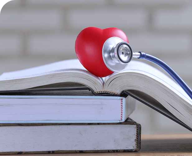 Books with stethoscope and heart